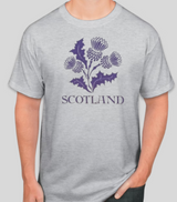Gray t-shirt with purple thistle design and 'Scotland' text on a plain background